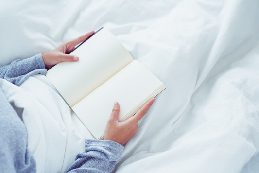 Hands holding an empty journal, ready to record dreams — symbolizing dream recall and self-reflection upon waking.